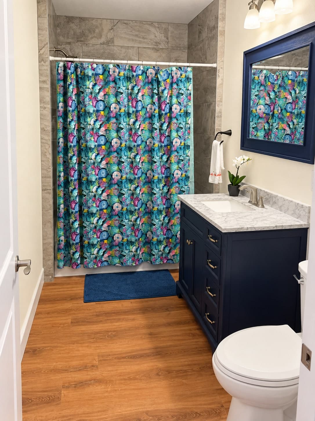 Coastal-themed bathroom with navy vanity