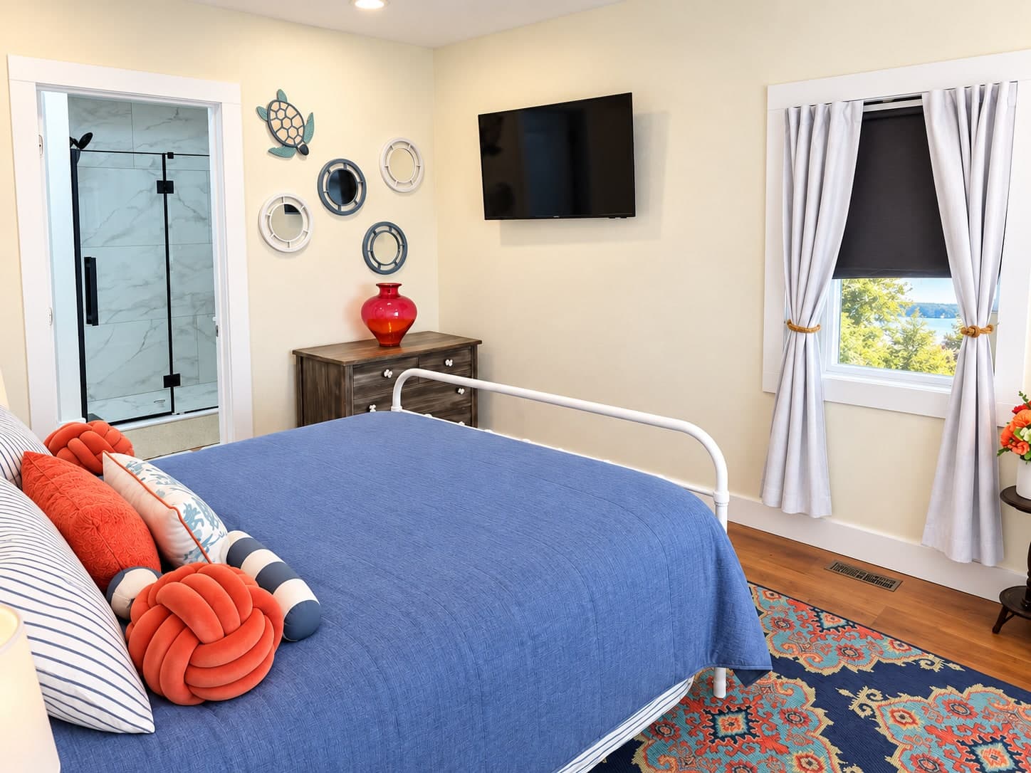 Guest bedroom with blue and coral coastal accents