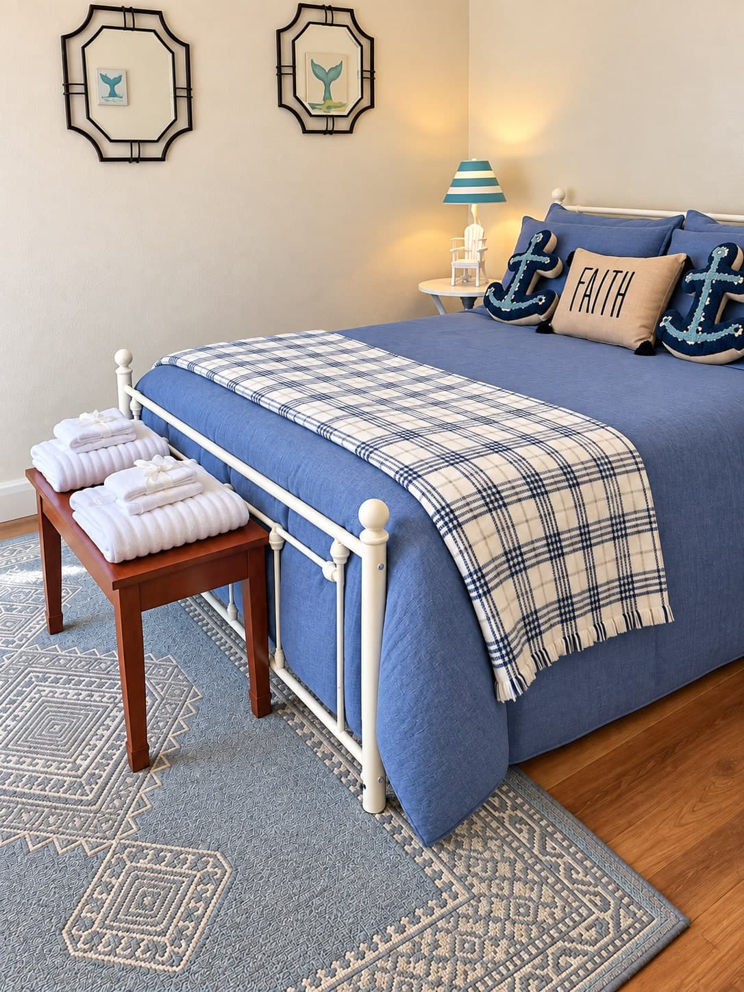 Guest bedroom with nautical navy accents and folded towels